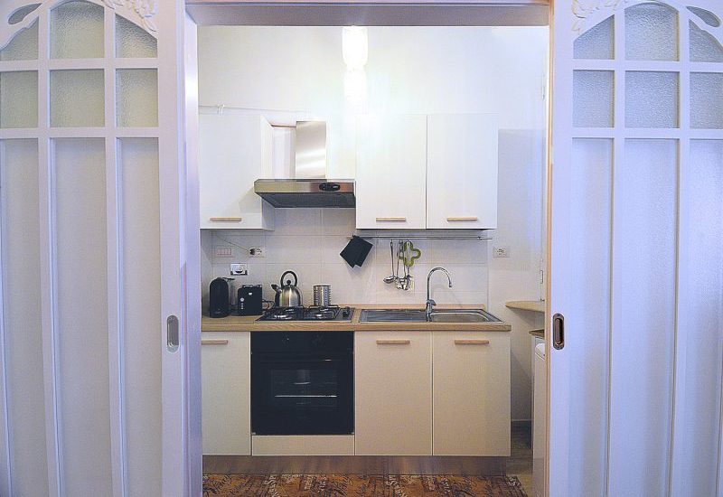 The large galley kitchen can be isolated behind sliding doors.