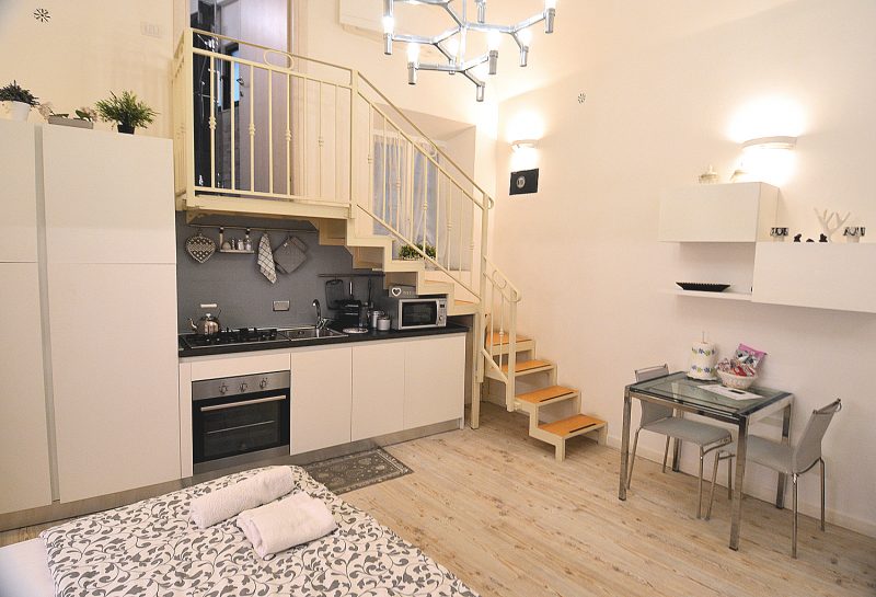 The Tiber Apartment's well-equipped kitchenette is tucked under the stairs leading to the mezzanine bathroom.