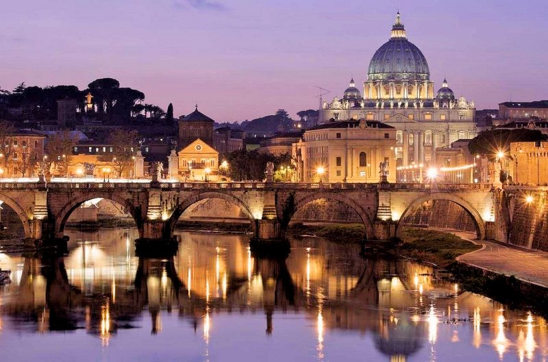 Vatican City at dusk reflected in the River Tiber.