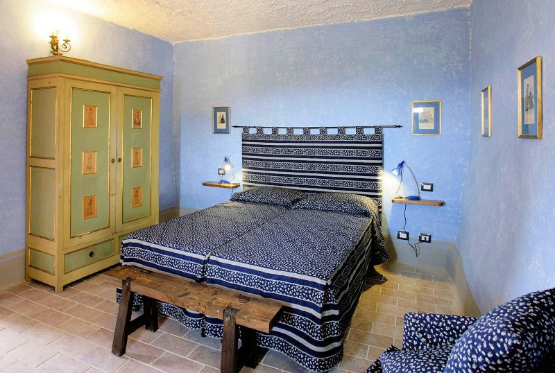 Apartment A's bedroom effuses Tuscan style.