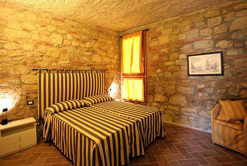 Apartment B's bedroom is classically Tuscan