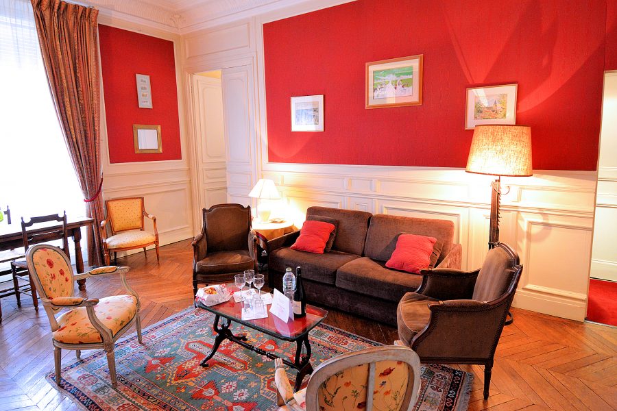 The large living room of the Orsay Apartment is the center room off of which the bedroom, bathroom, and kitchen are accessed.