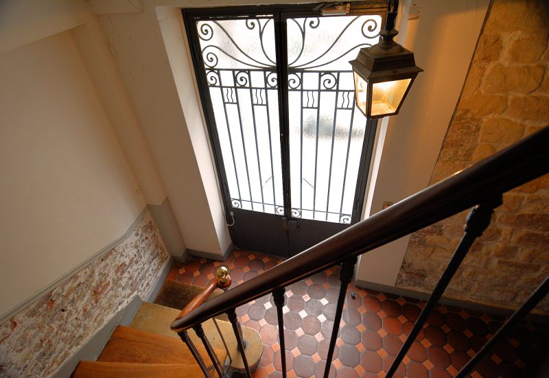 The Place des Galeries apartment is accessed via this door and two flights of stairs.
