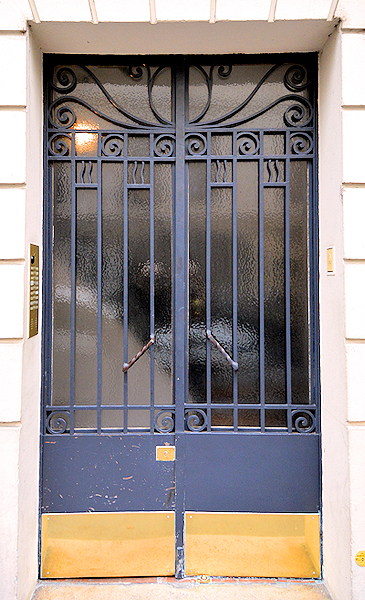 This code-operated secure entry door opens from a side street to access the stairway to the Place des Galeries apartment.