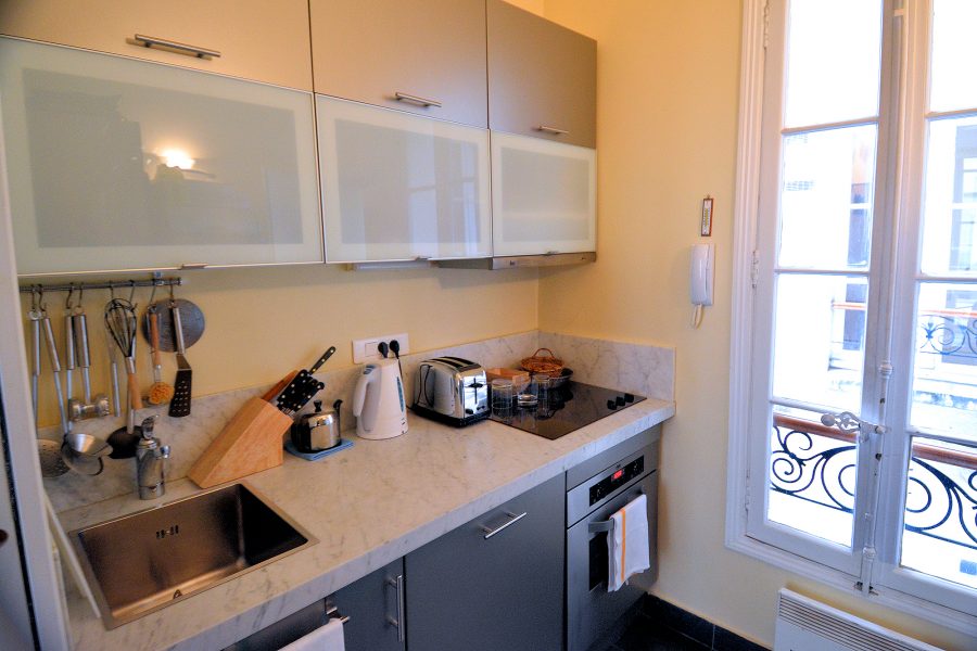 The Place des Galeries apartment kitchen is small but remarkably well-equipped.