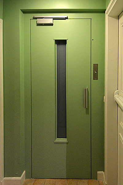 Small lift just outside the apartment entry door.