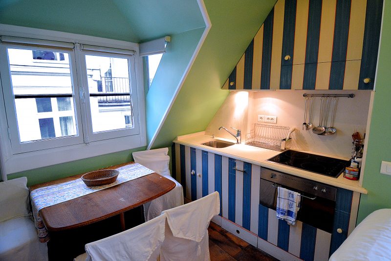 The upper floor kitchen is done in a French country style.