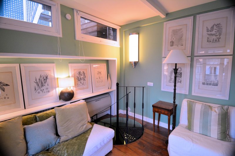 The spiral staircase leads from the lower floor to the upper floor living room.