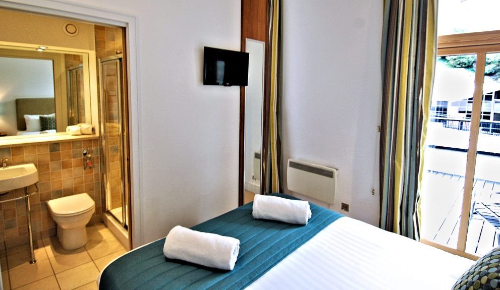 Bedroom 2, also with a king bed and en suite bathroom, has access to the furnished, wrap-around terrace.