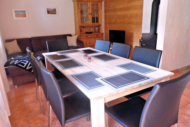 Chalet Bluemlisalp - dining room and living room with TV and Franklin stove