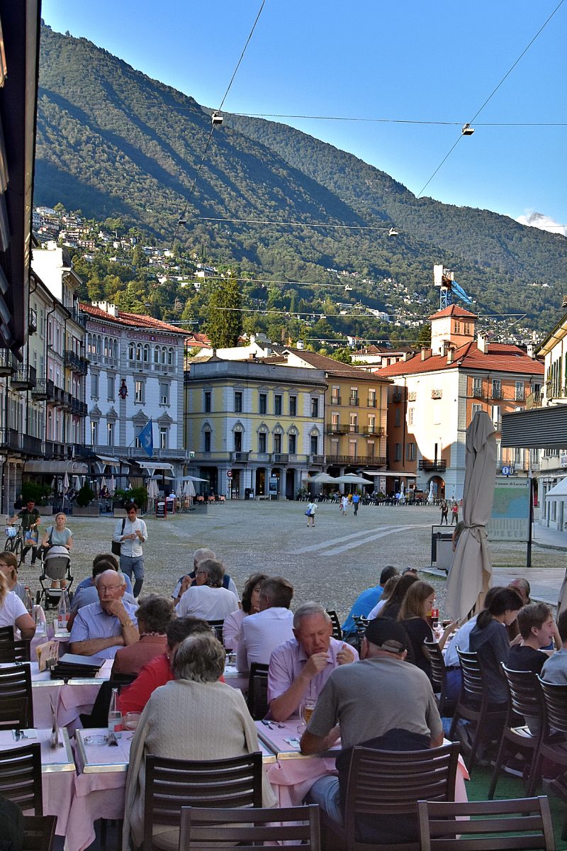 Diners on Piazza Grande at sunset
