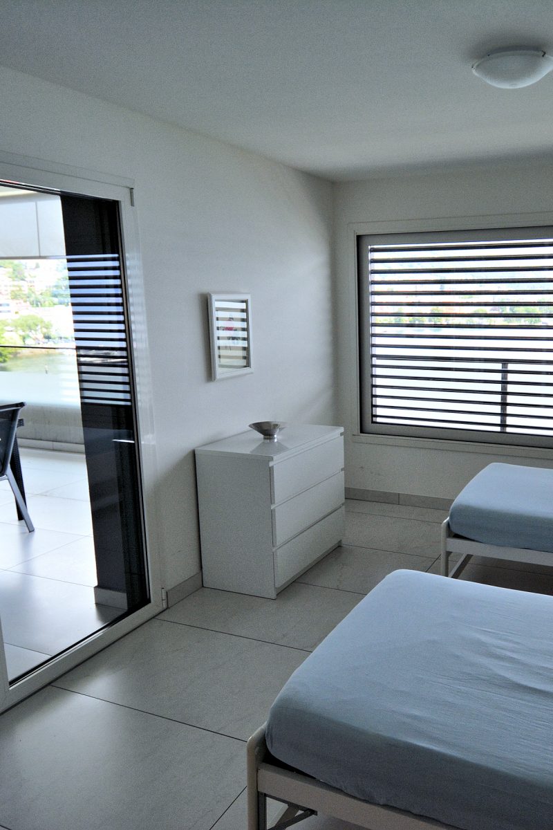 New Town - Premium Apartment — Twin bedroom with balcony access.