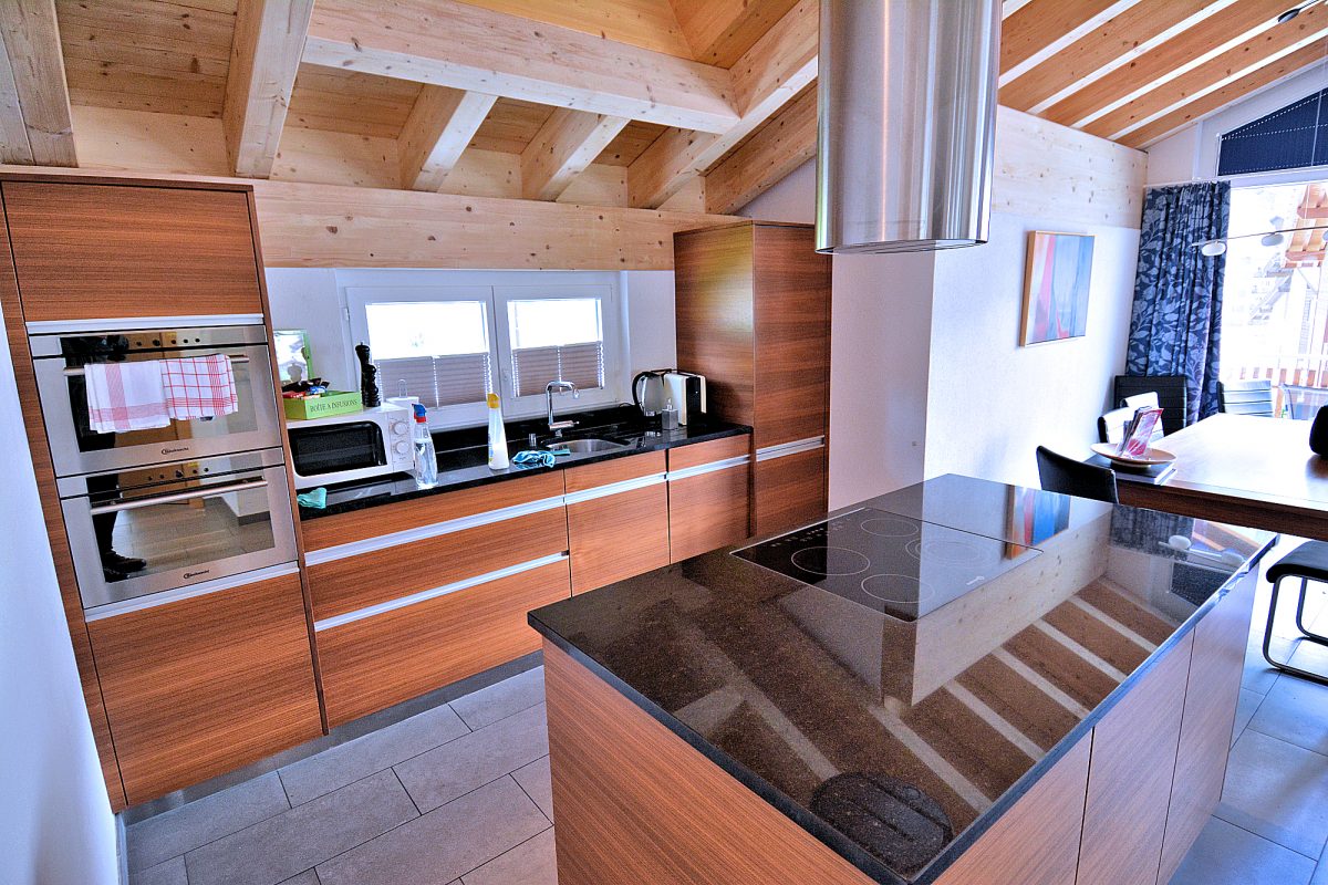 Highview Apt. — Kitchen with range island and dining area.