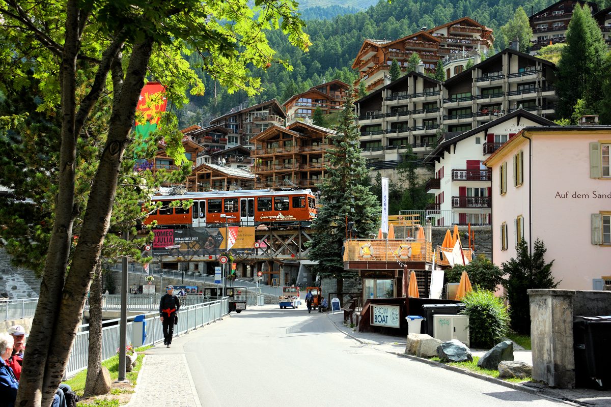 Gornergrat train departing congested Zermatt.
