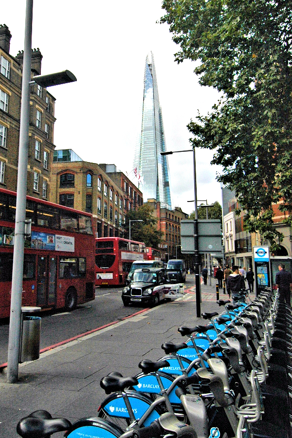 Buses, cabs, & bikes by the train station: cycle hire point near London Bridge Station.