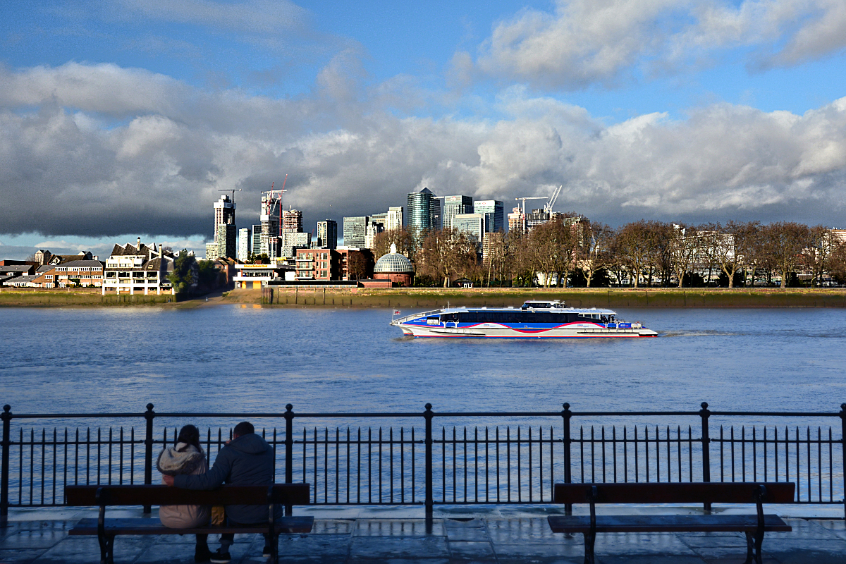 River cruiser passing Greenwich, the Isle of Dogs, and Canary Wharf westbound for central London.