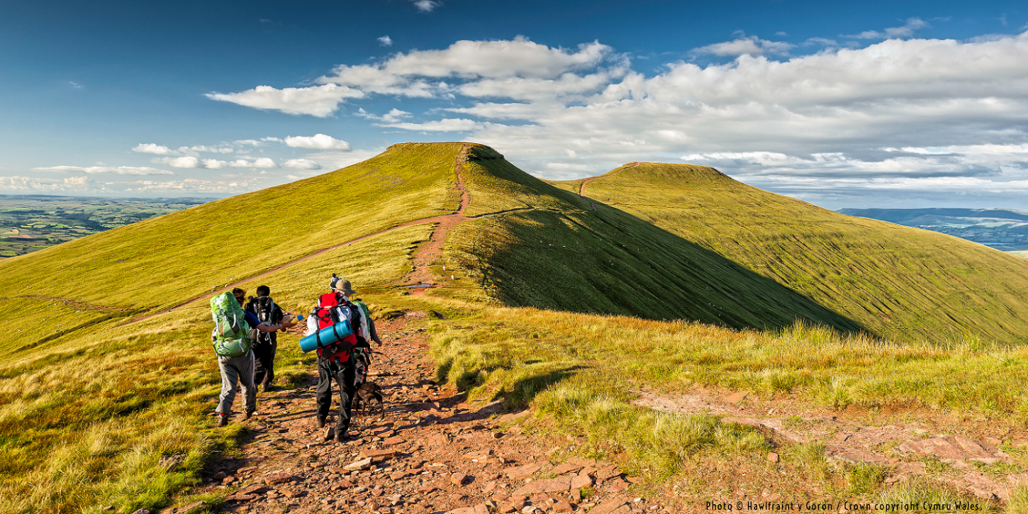 Brecon Beacons National Park in Mid-Wales: hikers for Pen y Fan peak. Photo © Hawlfraint y Goron / Crown copyright Cymru Wales.