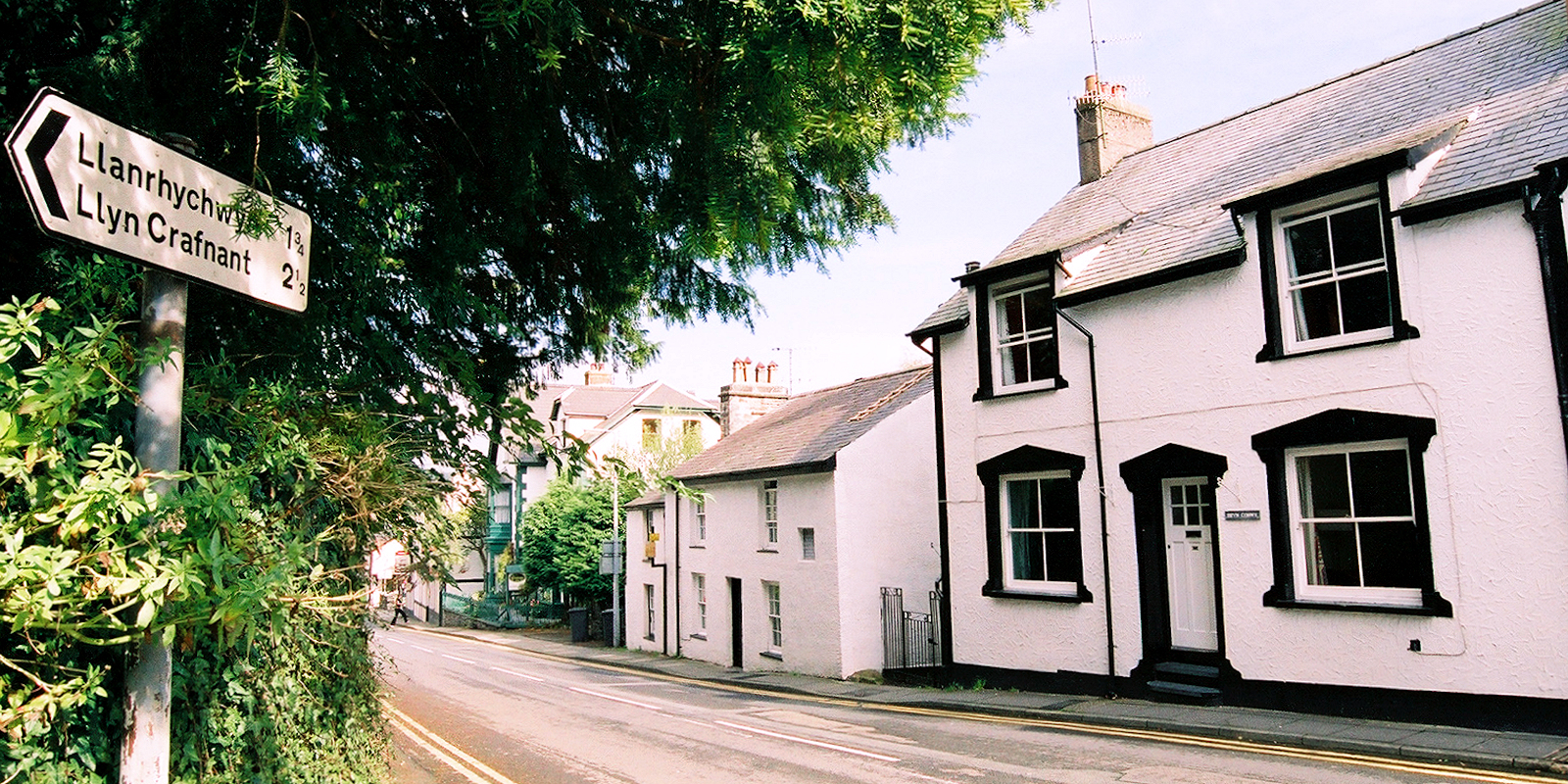 Welsh village with road signs. Photo copyright Home At First. Welsh village with road signs. Photo copyright Home At First.