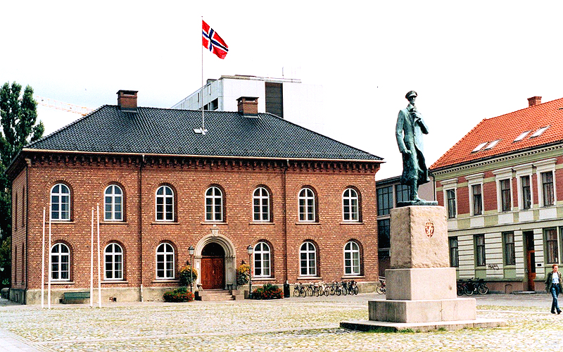 Southern Norway: Kristiansand's city hall square with statue of King Haakon VII. Photo © Home At First.
