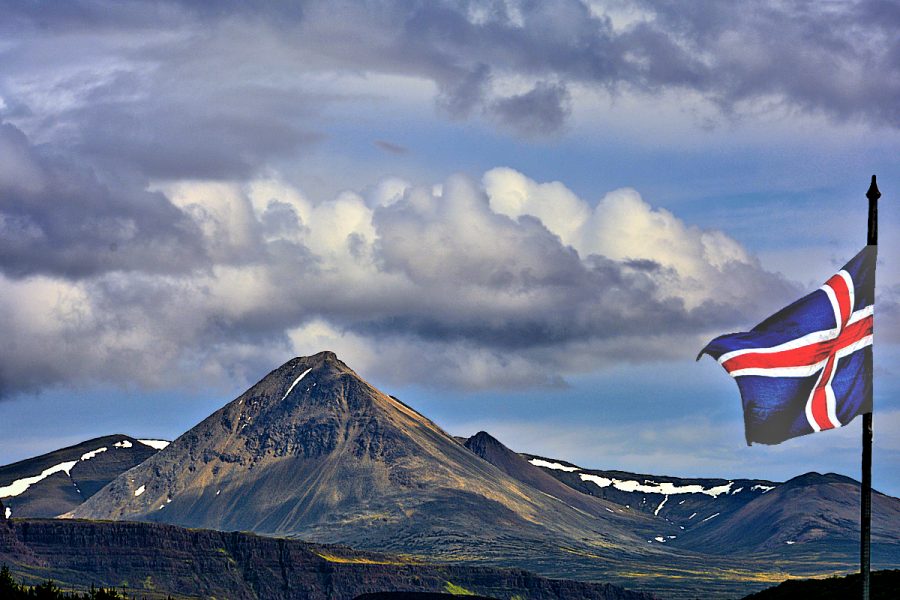 Iceland Landscapes: Volcanic landscape with Icelandic flag. Photo © Home At First.