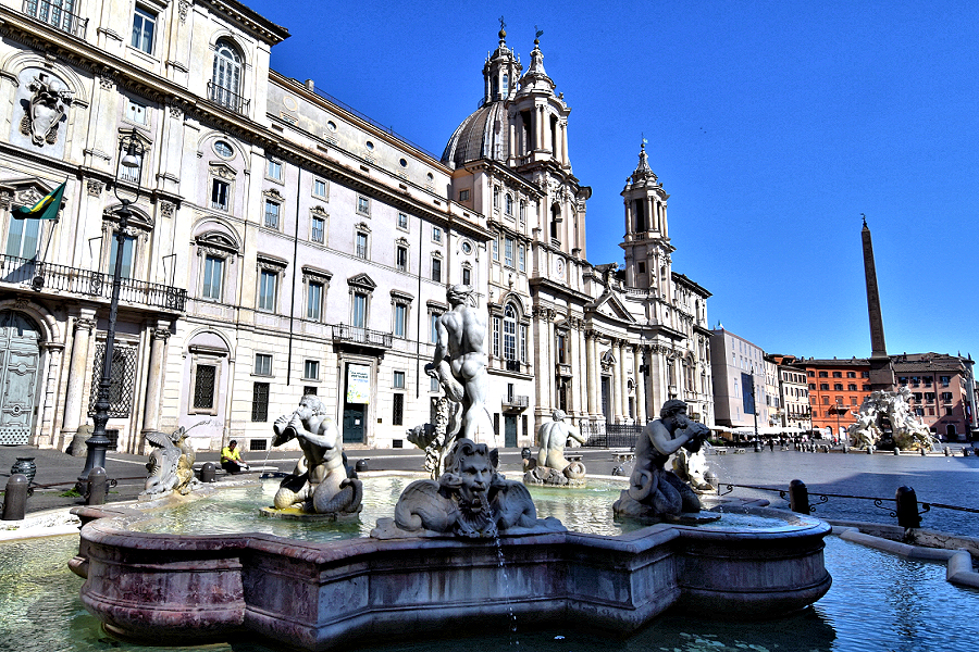 High Baroque buildings and fountains are found at Rome's Piazza Navona. Bernini's Neptune wrestles a dolphin as the centerpiece of the Fontana del Moro. Photo © Home At First.