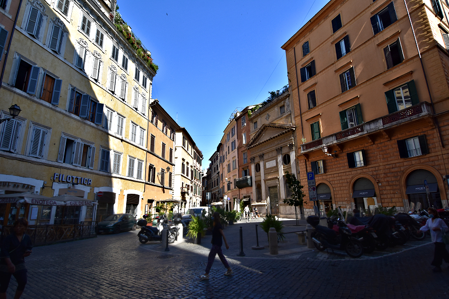 The streets of old central Rome are a maze of narrow alleys that invite exploring. At some intersections, like here at Piazza di Pasquino, the space opens enough to let the Roman sun shine in. Photo © Home At First.
