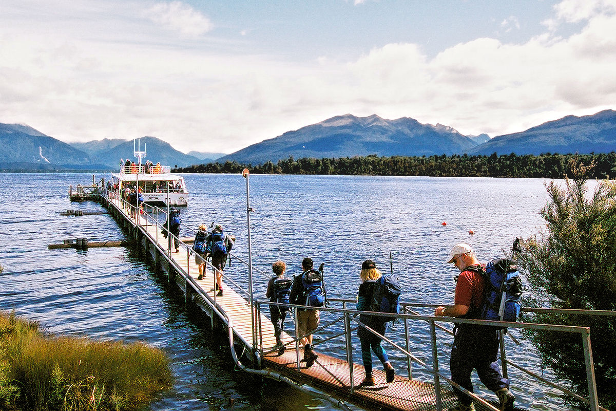 South Island: Fiordland — Hikers for Milford Track embark at Te Anau Downs. Photo © Home At First.