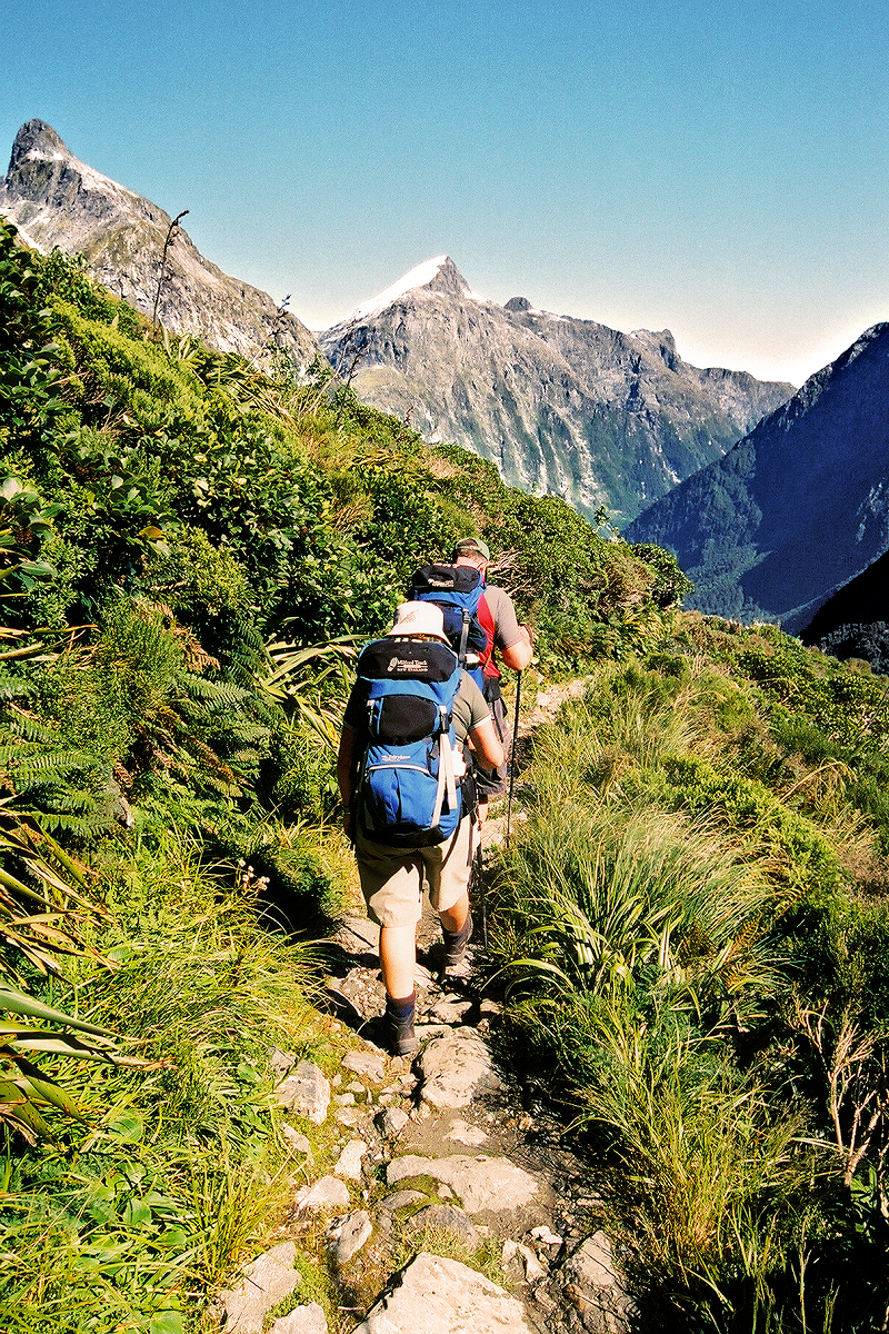 South Island: Fiordland — Milford Track hikers crossing Mackinnon Pass. Photo © Home At First.