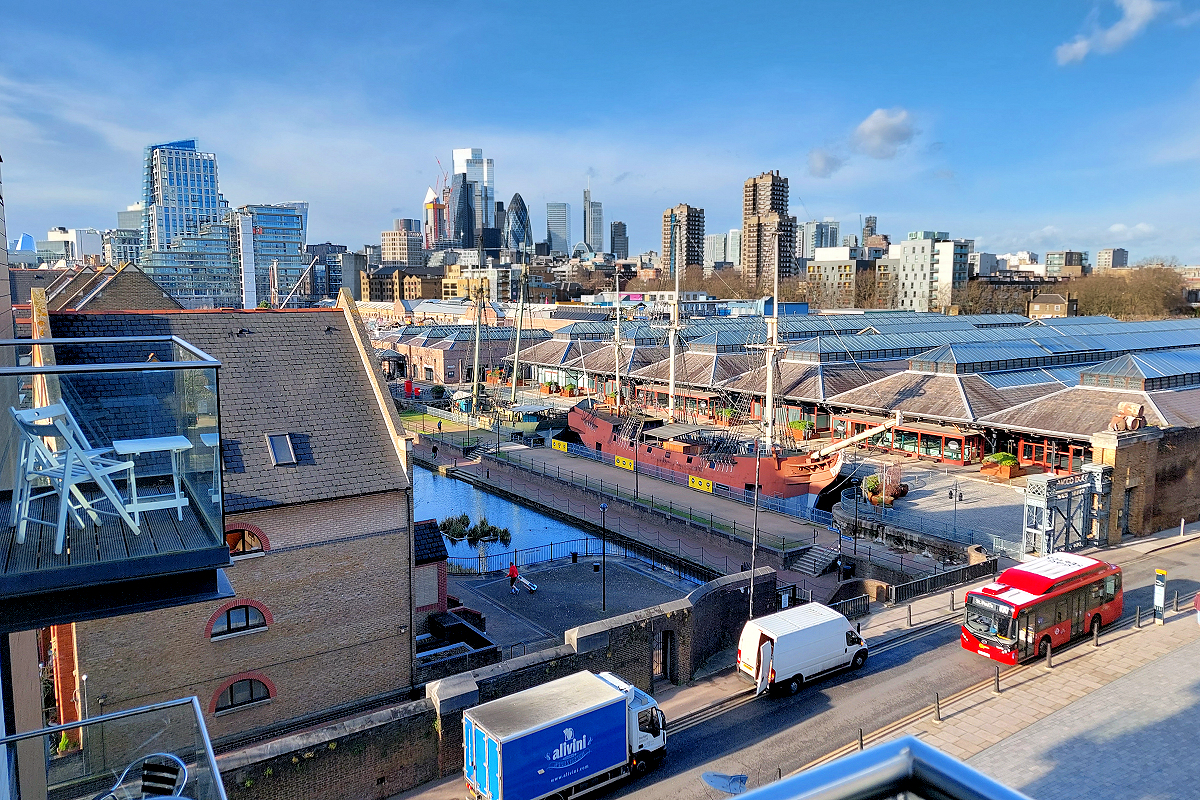 London: Tower Hamlets, Wapping — Tobacco Dock Apartment - Balcony view of Tobacco Dock and The City. Photo © Home At First.