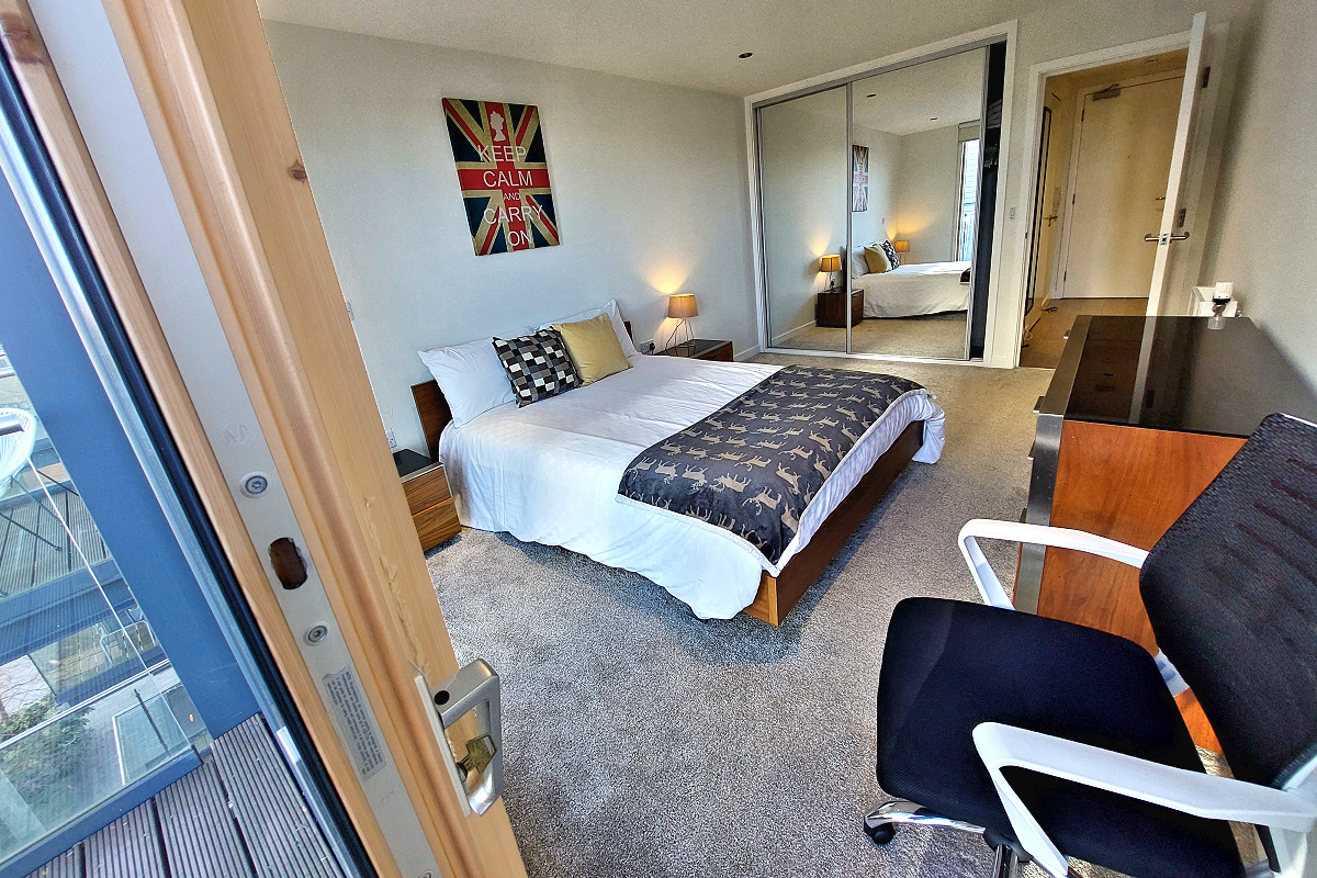 London: Tower Hamlets, Wapping — Tobacco Dock Apartment - Balcony view of the King Bedroom. Photo © Home At First.