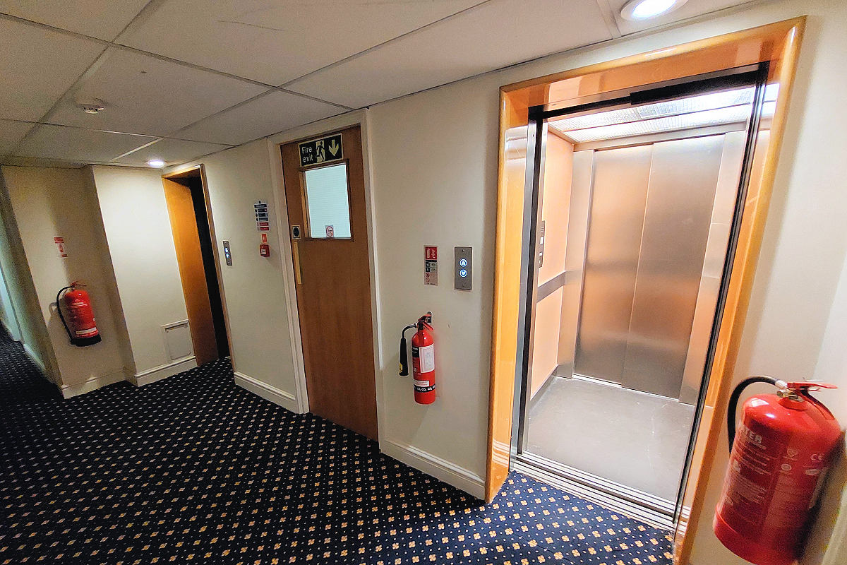 London: Tower Hamlets, Whitechapel — Jack the Ripper Apt. - Hallway Elevators. Photo © Home At First.