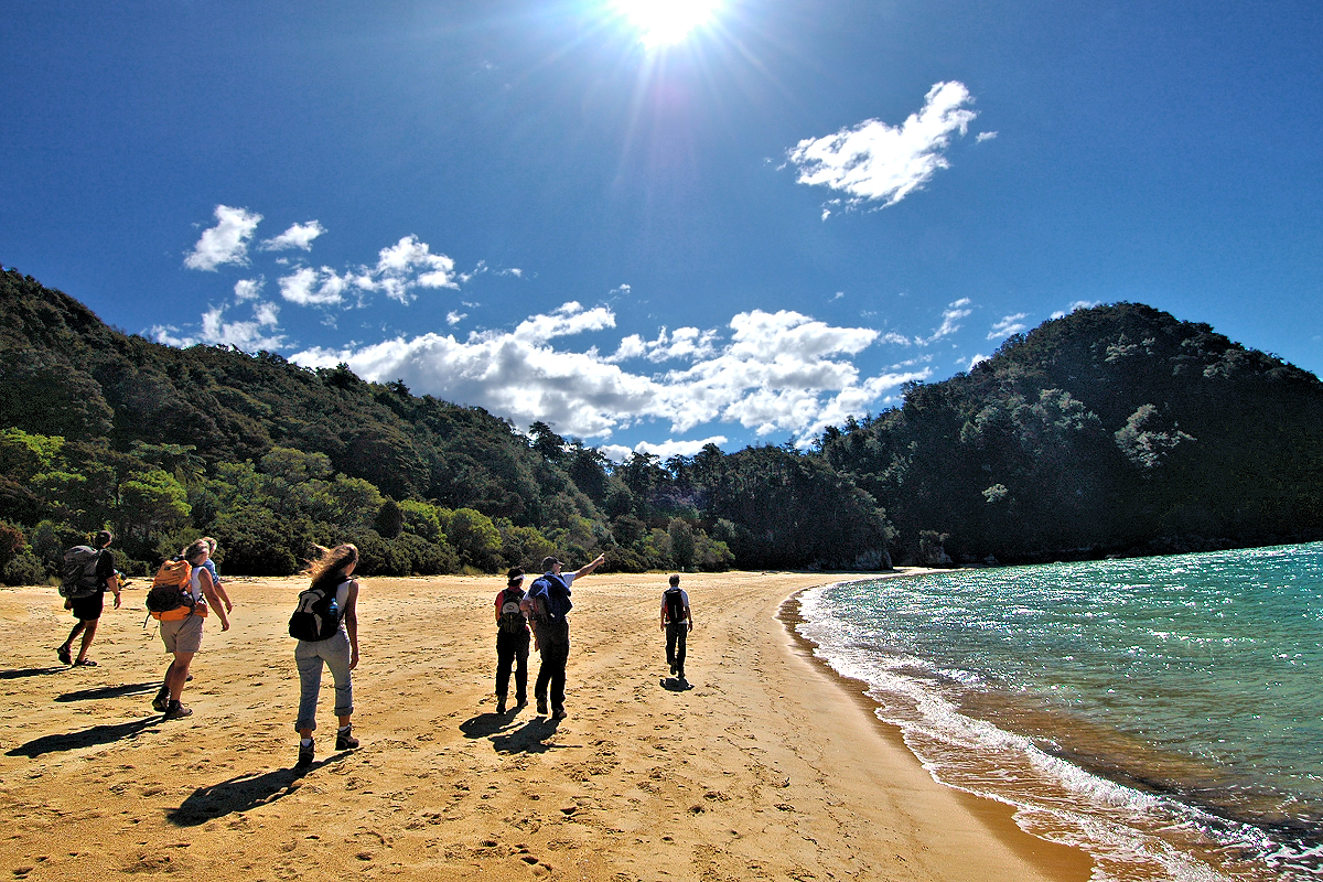 Nelson Region: Abel Tasman Coast Track hiking on the beach. Photo © Home At First.
