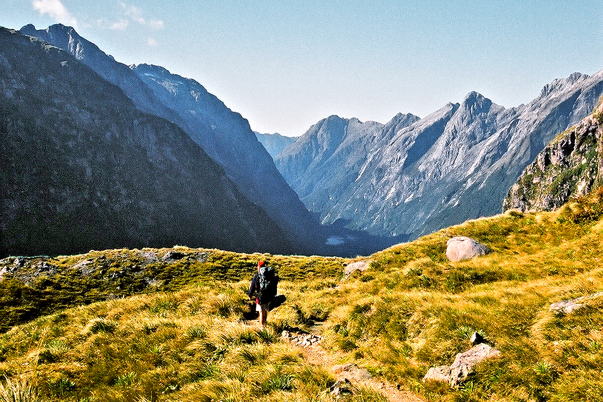 Fiordland - Milford Track - Solo hiker atop Mackinnon Pass. Photo © Home At First.