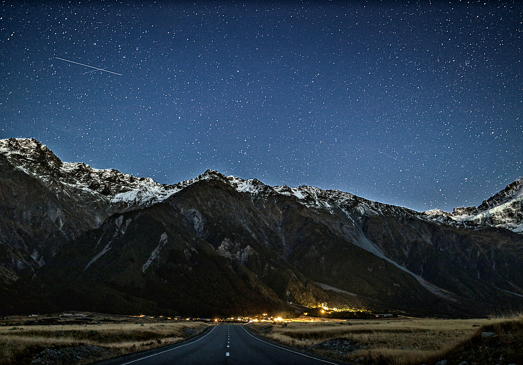 Mackenzie Country - night falls on Mt Cook village and the Southern Alps. NZ Tourism Photo by Miles Holden.