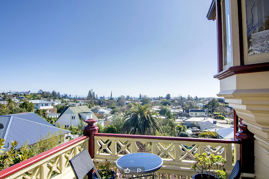 Nelson: Victorian Inn - furnished balcony with view overlooking Nelson. Photo courtesy the owners.